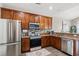 Well-equipped kitchen with stainless steel appliances, granite countertops, and wood cabinetry at 4697 Farm Lake Dr., Myrtle Beach, SC 29579