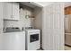 Functional laundry room with modern appliances, storage cabinets, and convenient access at 4697 Farm Lake Dr., Myrtle Beach, SC 29579