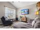 Living room with comfortable seating, a mounted TV, and a large window at 4697 Farm Lake Dr., Myrtle Beach, SC 29579