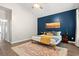 Bedroom with a cozy bed, stylish accent wall, wood floors, and an area rug at 4697 Farm Lake Dr., Myrtle Beach, SC 29579