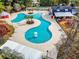 Aerial view of community pool showcasing unique shape, lounge areas, and convenient amenities at 4697 Farm Lake Dr., Myrtle Beach, SC 29579