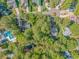 Aerial view showcasing homes with mature trees, winding roads, and lush landscaping within the community at 5 Old Barge Dr., Pawleys Island, SC 29585