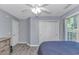 Cozy bedroom with gray-toned walls, wood-look floors, double closets, and a ceiling fan at 5 Old Barge Dr., Pawleys Island, SC 29585