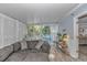 Cozy sunroom with comfortable seating, light wood floors, and bright natural light from the large sliding glass doors at 5 Old Barge Dr., Pawleys Island, SC 29585