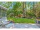 A beautiful backyard featuring a lush lawn surrounded by mature trees at 5 Old Barge Dr., Pawleys Island, SC 29585