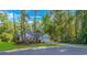 Charming single-story home nestled among mature trees with a well-manicured lawn and attached garage at 5 Old Barge Dr., Pawleys Island, SC 29585