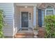 Inviting front porch with brick steps, decorative columns, and a beautifully adorned front door at 5 Old Barge Dr., Pawleys Island, SC 29585