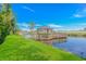 Charming wooden gazebo on a dock surrounded by water, marsh grasses, and a manicured green lawn at 5 Old Barge Dr., Pawleys Island, SC 29585