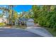 Attractive home exterior with a long driveway, attached garage, and mature trees in a landscaped yard at 5 Old Barge Dr., Pawleys Island, SC 29585
