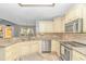 Modern kitchen with granite countertops, stainless steel appliances, and ample cabinetry for storage at 5 Old Barge Dr., Pawleys Island, SC 29585