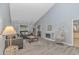 Bright living room with vaulted ceilings, comfortable seating, a fireplace, and an accent hanging chair at 5 Old Barge Dr., Pawleys Island, SC 29585