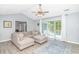 Spacious living room with stylish sofa and a large sliding glass door leading to the outdoor patio at 5 Old Barge Dr., Pawleys Island, SC 29585