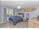 Comfortable bedroom with a surfboard wall decoration, a large window and light wood finishes at 5 Old Barge Dr., Pawleys Island, SC 29585