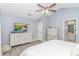 Bright main bedroom featuring neutral decor, white dressers, and access to an ensuite bathroom at 5 Old Barge Dr., Pawleys Island, SC 29585