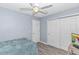 Functional bedroom with light blue walls, minimalist decor, a ceiling fan, and closet storage at 5 Old Barge Dr., Pawleys Island, SC 29585