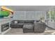 Inviting sunroom with a fireplace, plush sectional sofa, and ample natural light at 5 Old Barge Dr., Pawleys Island, SC 29585