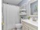 Clean, well-lit bathroom with fresh white towels, a sleek vanity, and a decorative shower curtain at 5 Old Barge Dr., Pawleys Island, SC 29585