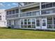 Rear exterior of the property showcasing the windows, doors, and lawn at 500 Fairway Village Dr. # 7-C, Myrtle Beach, SC 29588