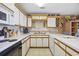 Charming kitchen with white cabinets, stylish backsplash, and modern appliances, perfect for cooking at 500 Fairway Village Dr. # 7-C, Myrtle Beach, SC 29588