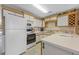 Well-lit kitchen showcasing white cabinets, appliances, and ample countertop space for meal preparation at 500 Fairway Village Dr. # 7-C, Myrtle Beach, SC 29588
