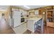 Bright kitchen featuring white appliances, cabinets, and a cozy breakfast bar with barstool seating at 500 Fairway Village Dr. # 7-C, Myrtle Beach, SC 29588