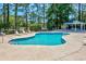 Community pool area with lounge chairs, lush trees, and shade at 500 Fairway Village Dr. # 7-C, Myrtle Beach, SC 29588
