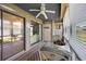 Cozy sunroom featuring a ceiling fan, glass table and view into the living room at 500 Fairway Village Dr. # 7-C, Myrtle Beach, SC 29588