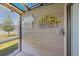 View of the sunroom wall decorations and lawn from inside the sunroom at 500 Fairway Village Dr. # 7-C, Myrtle Beach, SC 29588