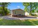 Rear exterior view of home with brick foundation and gravel driveway at 509 S Rosemary Ave., Andrews, SC 29510