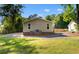 Rear exterior view of home with brick foundation and gravel driveway at 509 S Rosemary Ave., Andrews, SC 29510