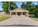 Charming single-story home features a covered porch with white pillars and a large concrete driveway at 509 S Rosemary Ave., Andrews, SC 29510