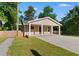 Inviting single-story home with a covered entrance, showcasing a well-maintained lawn and a fenced yard at 509 S Rosemary Ave., Andrews, SC 29510