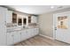 Bright kitchen features white cabinetry, granite countertops, a stainless steel sink, and wood-look flooring at 509 S Rosemary Ave., Andrews, SC 29510
