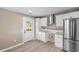 Modern kitchen showcases white cabinetry, stainless steel appliances, and wood-look flooring at 509 S Rosemary Ave., Andrews, SC 29510