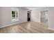 Inviting living room featuring wood-look flooring, a large window and a dark-stained wood door at 509 S Rosemary Ave., Andrews, SC 29510
