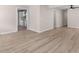 Bright living room featuring luxury vinyl plank flooring and an open doorway leading to the kitchen at 509 S Rosemary Ave., Andrews, SC 29510