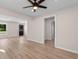 Open-concept living room with modern ceiling fan and light-colored laminate flooring and entry to other rooms at 509 S Rosemary Ave., Andrews, SC 29510