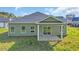 Exterior view of the home with a covered patio and a grassy yard at 534 War Eagle Ct., Conway, SC 29526
