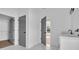 Bathroom featuring marble floors, gray doors, white vanity with dual sinks, and walk-in closet at 534 War Eagle Ct., Conway, SC 29526