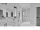 Bright bathroom with marble shower, white dual sink vanity, black accents and gray door at 534 War Eagle Ct., Conway, SC 29526