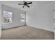 A bright bedroom features carpeted floors, a ceiling fan, and natural light from the two windows at 534 War Eagle Ct., Conway, SC 29526