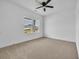 Simple bedroom with carpet, white walls, a ceiling fan, and a large window at 534 War Eagle Ct., Conway, SC 29526