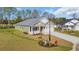 Attractive single-story home with white brick accents, attached garage, and a lush green yard at 534 War Eagle Ct., Conway, SC 29526