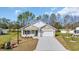 Charming single-story home with a white brick facade, green accents, and a spacious driveway at 534 War Eagle Ct., Conway, SC 29526