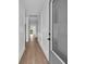 Bright hallway with wood floors, white trim, and doors leading to other rooms at 534 War Eagle Ct., Conway, SC 29526
