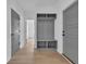 Hallway with wood floors and a built-in storage bench and coat rack, next to gray interior doors at 534 War Eagle Ct., Conway, SC 29526