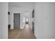 Bright hallway featuring wood floors, white trim, and gray doors leading to other rooms at 534 War Eagle Ct., Conway, SC 29526