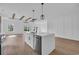 Modern kitchen with stainless appliances, stone countertops, and island with pendant lights at 534 War Eagle Ct., Conway, SC 29526