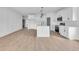 Bright kitchen and island features white cabinets, stainless appliances, and laminate flooring at 534 War Eagle Ct., Conway, SC 29526