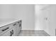 Well lit laundry room boasts decorative tile floor, sleek countertops, and ample storage at 534 War Eagle Ct., Conway, SC 29526